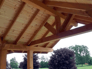 A view of underneath a roof - featuring exposed structural beams