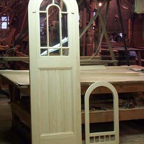Custom round top combination door with 8 true divided lights. The curved muntins which divide the glass are particularly difficult to master.