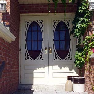 A pair of "Steve" style combination storm/screen doors