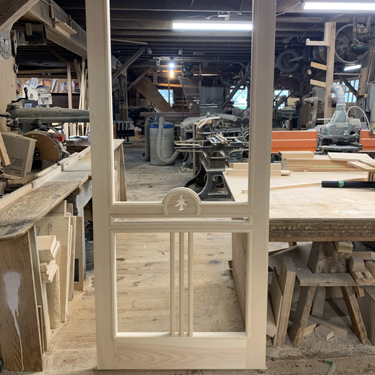 A custom crafted tree design incorporated into a unique screen door. Made from clear pine.